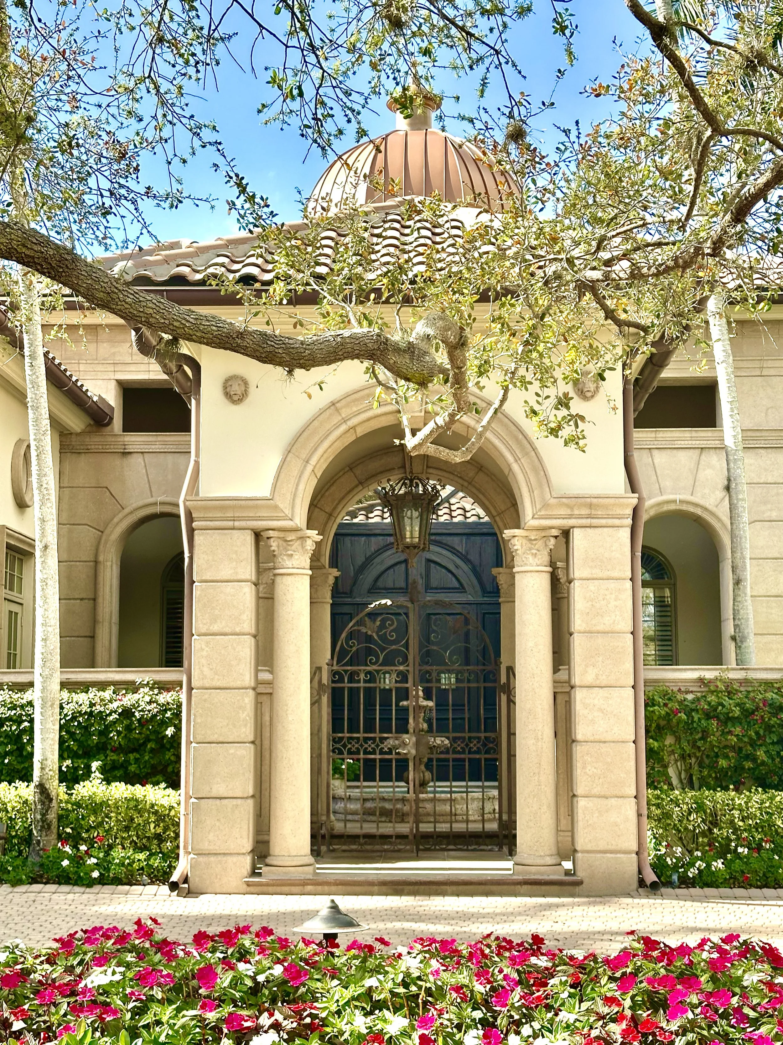 Mediterranean columns and arched entrance to residence in Jupiter
