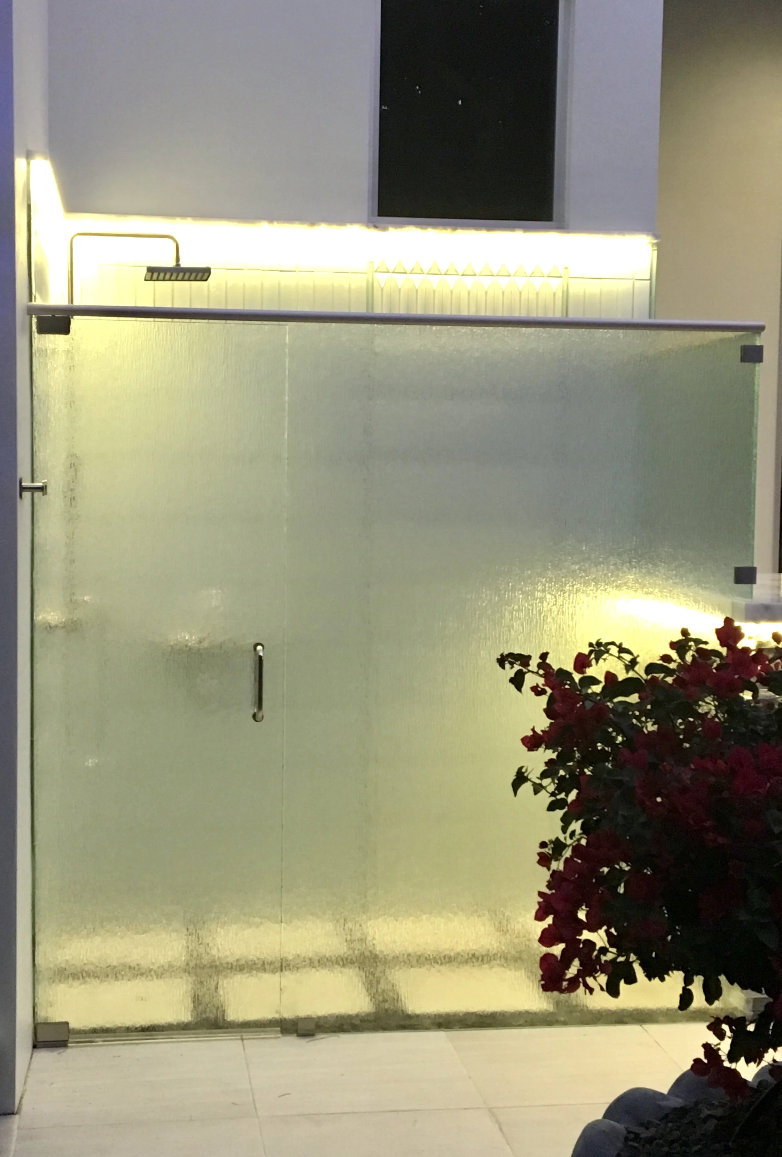 modern outdoor tile shower with glass and stone enclosure