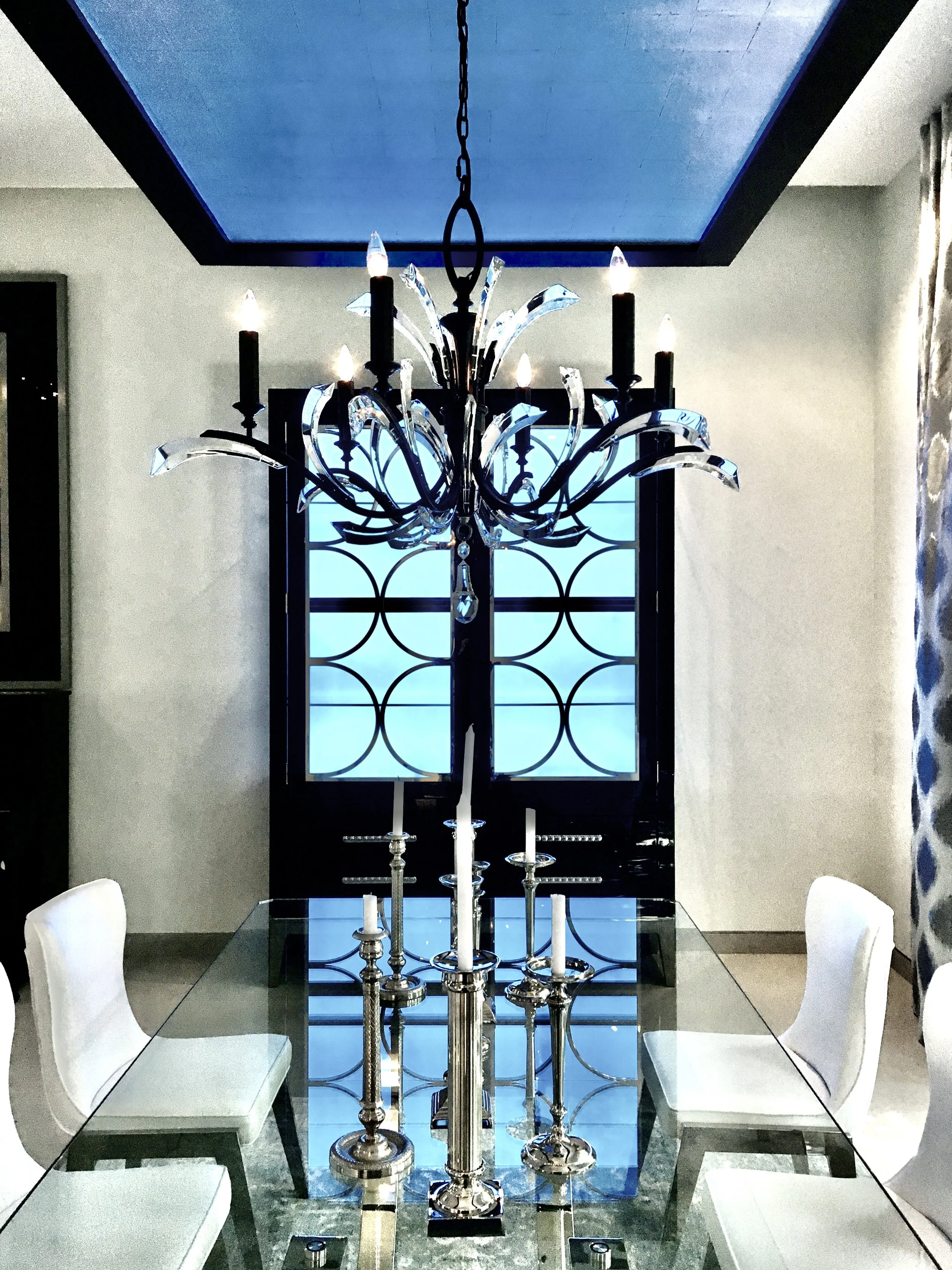 luxury dining room with custom cabinetry hutch and modern crystal chandelier