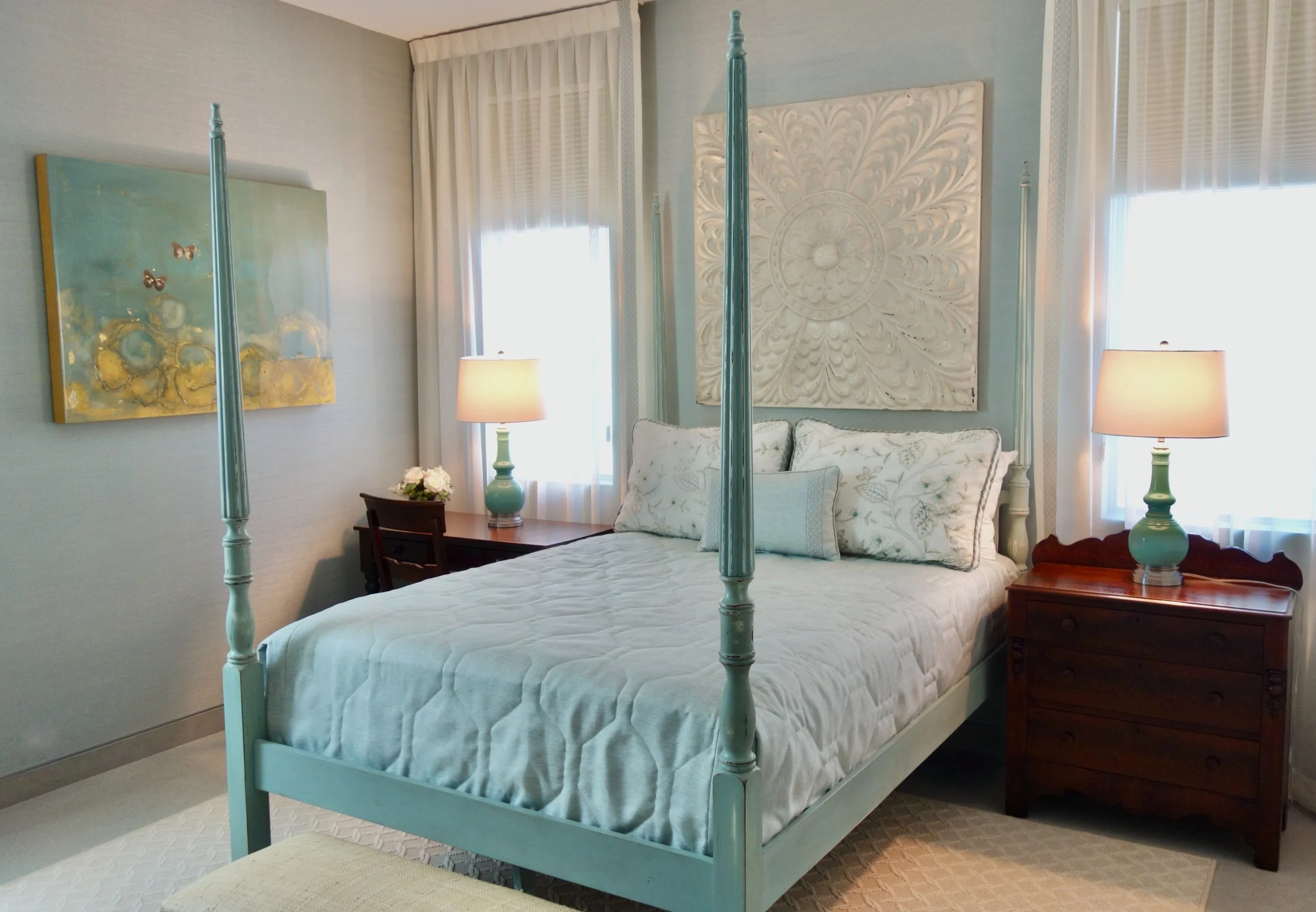 modern tropical bedroom in aqua with a four poster bed