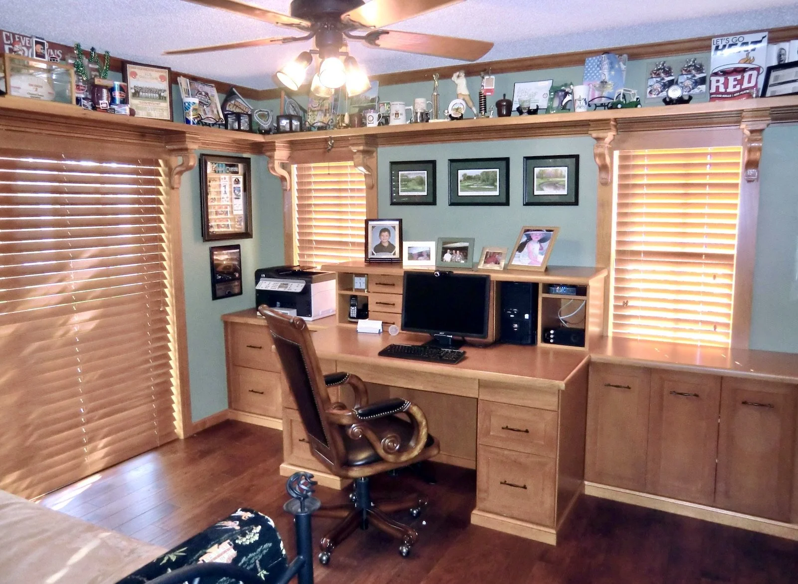 transitional home office with golden maple with shelf on two walls held by traditional corbels