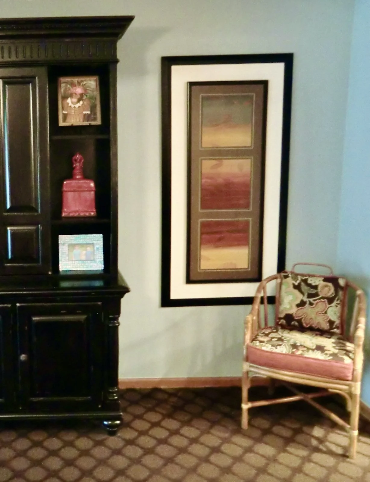 Coast bedroom with dark Tommy Bahamas wallunit and bamboo chair with tropical fabric