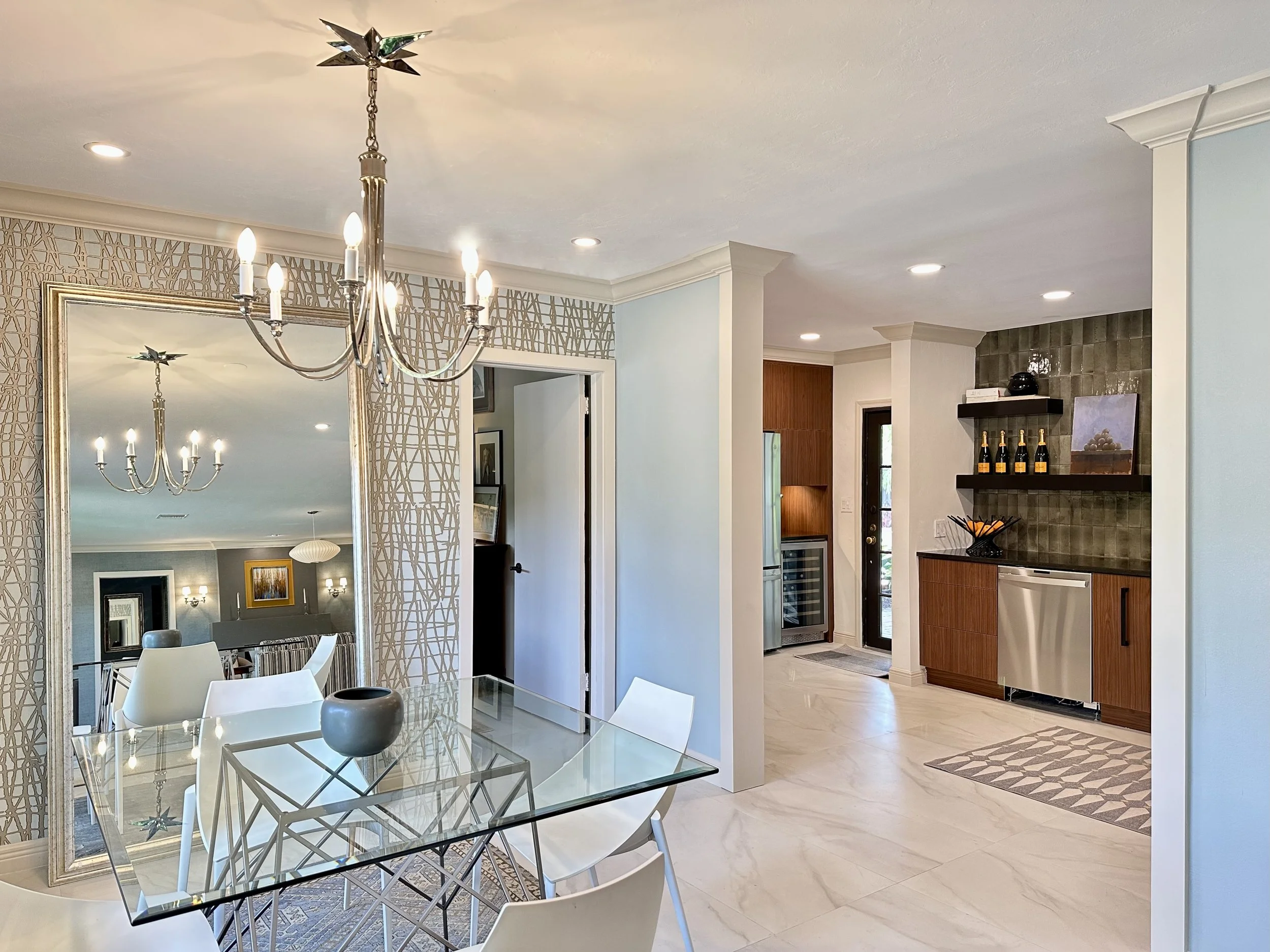 Modern eating area looking into a Mid Century style kitchen with traditional molding at enterance