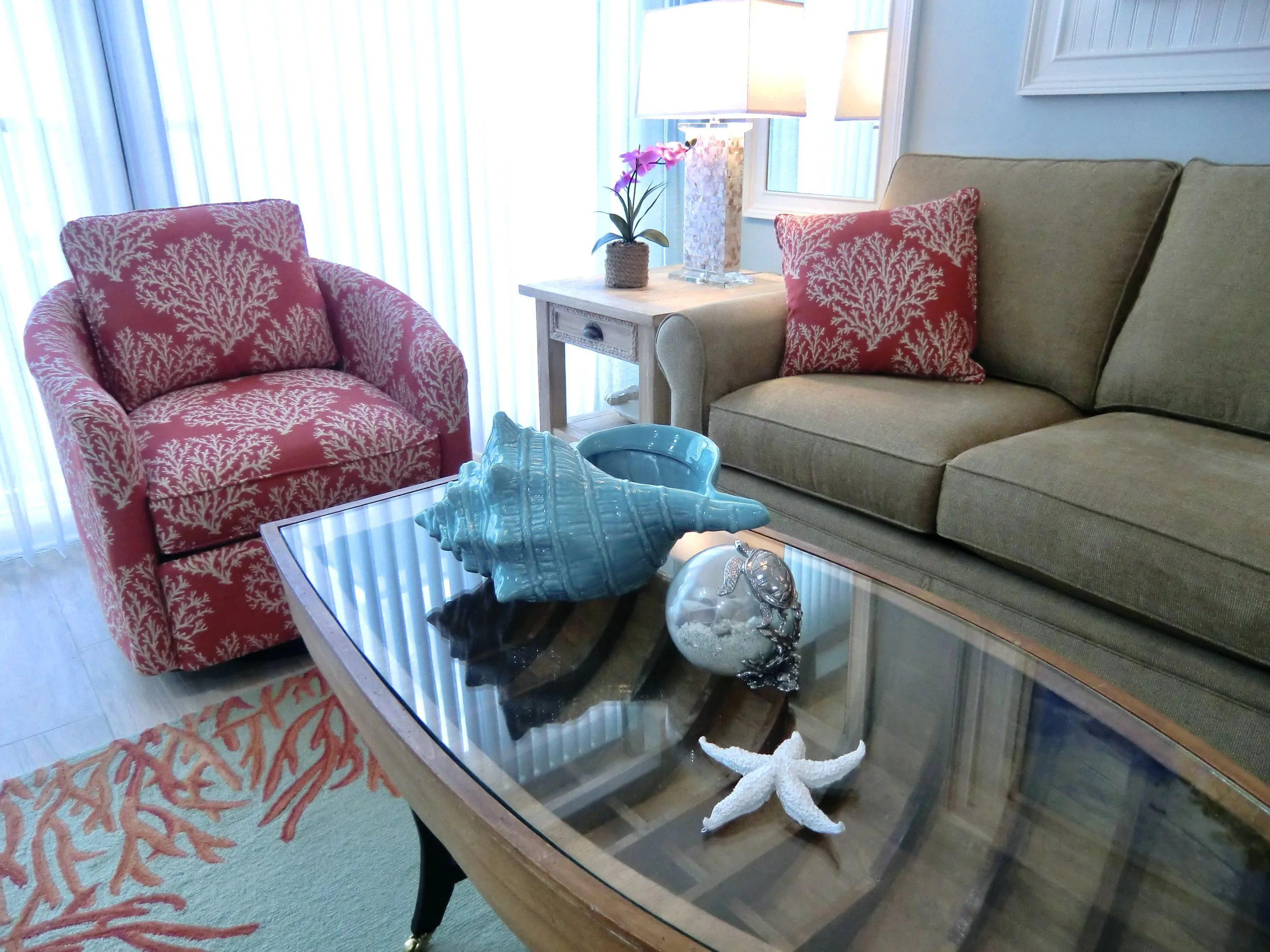 modern coastal living room with red coral chair and boat coffee table in the Florida Keys
