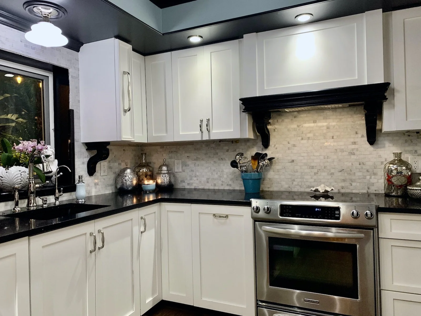 new kitchen with white custom cabinets, black moldings and corbels in Fort Lauderdale