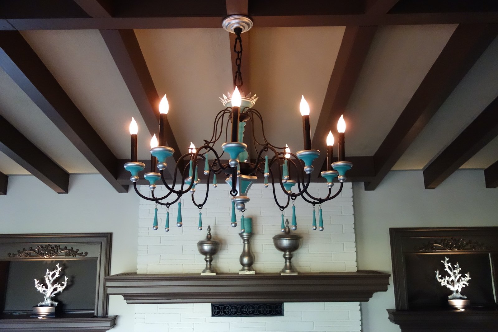mediterranean wrought iron chandelier in front of fireplace