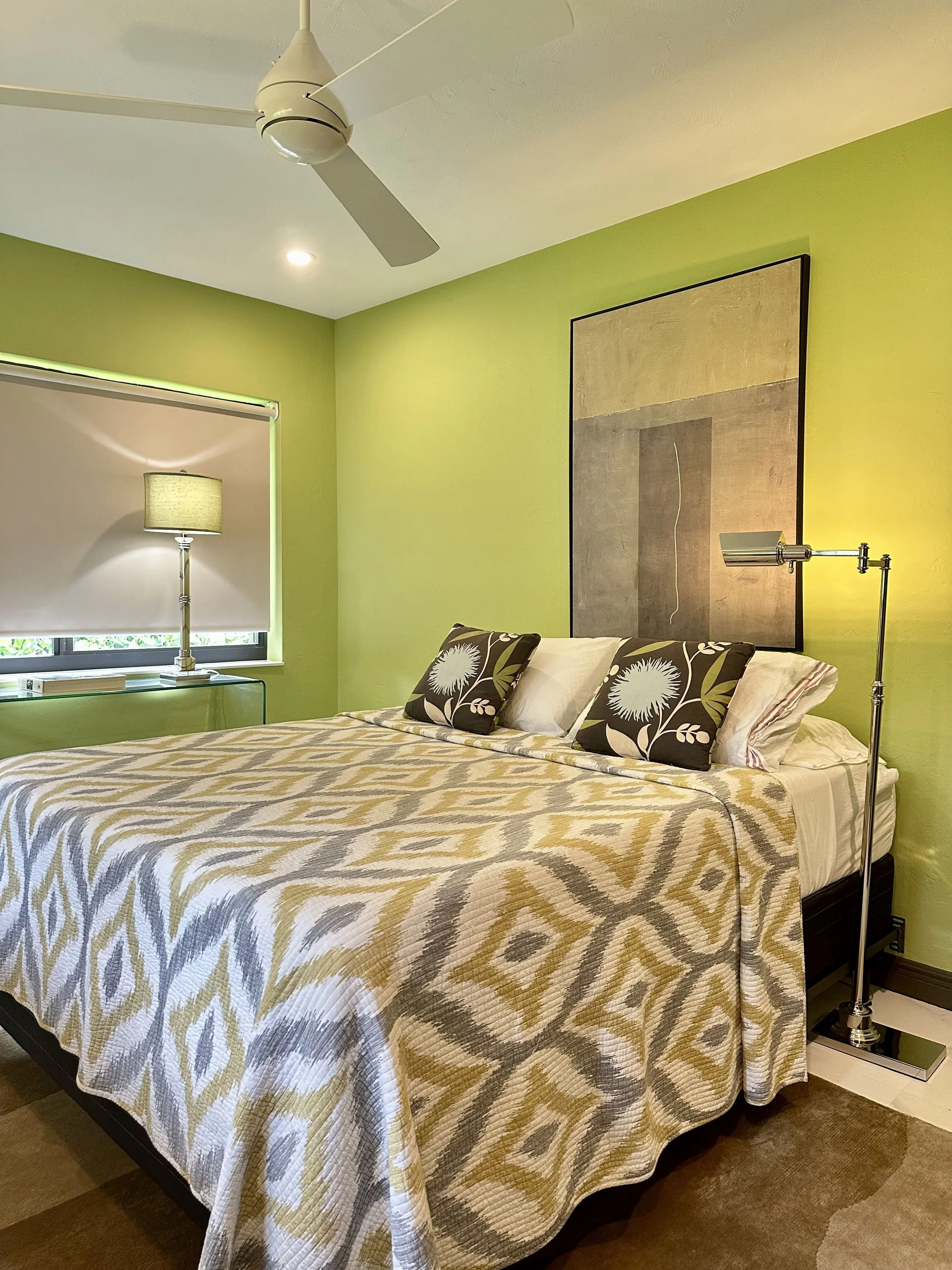 modern bedroom with lime green walls and dark brown moldings and doors in Fort Lauderdale