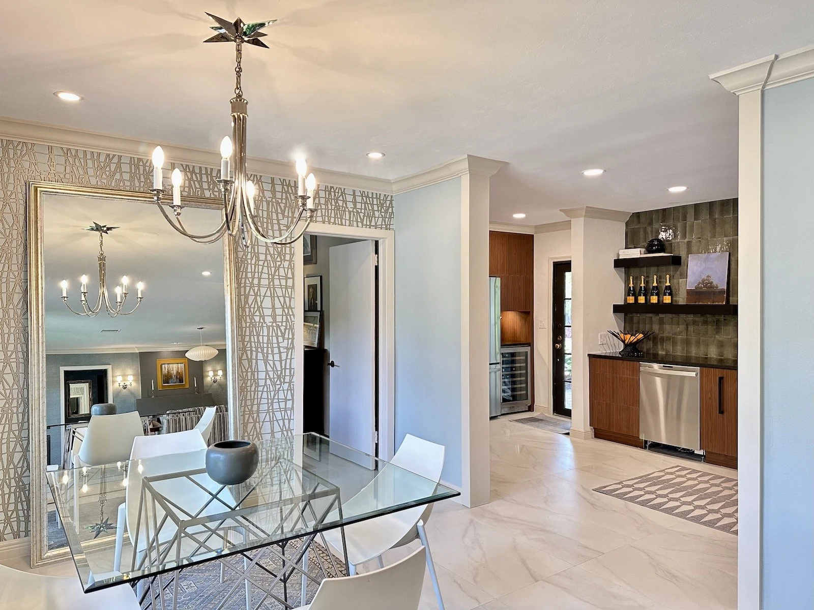 Modern eating area looking into a Mid Century style kitchen with traditional molding at enterance