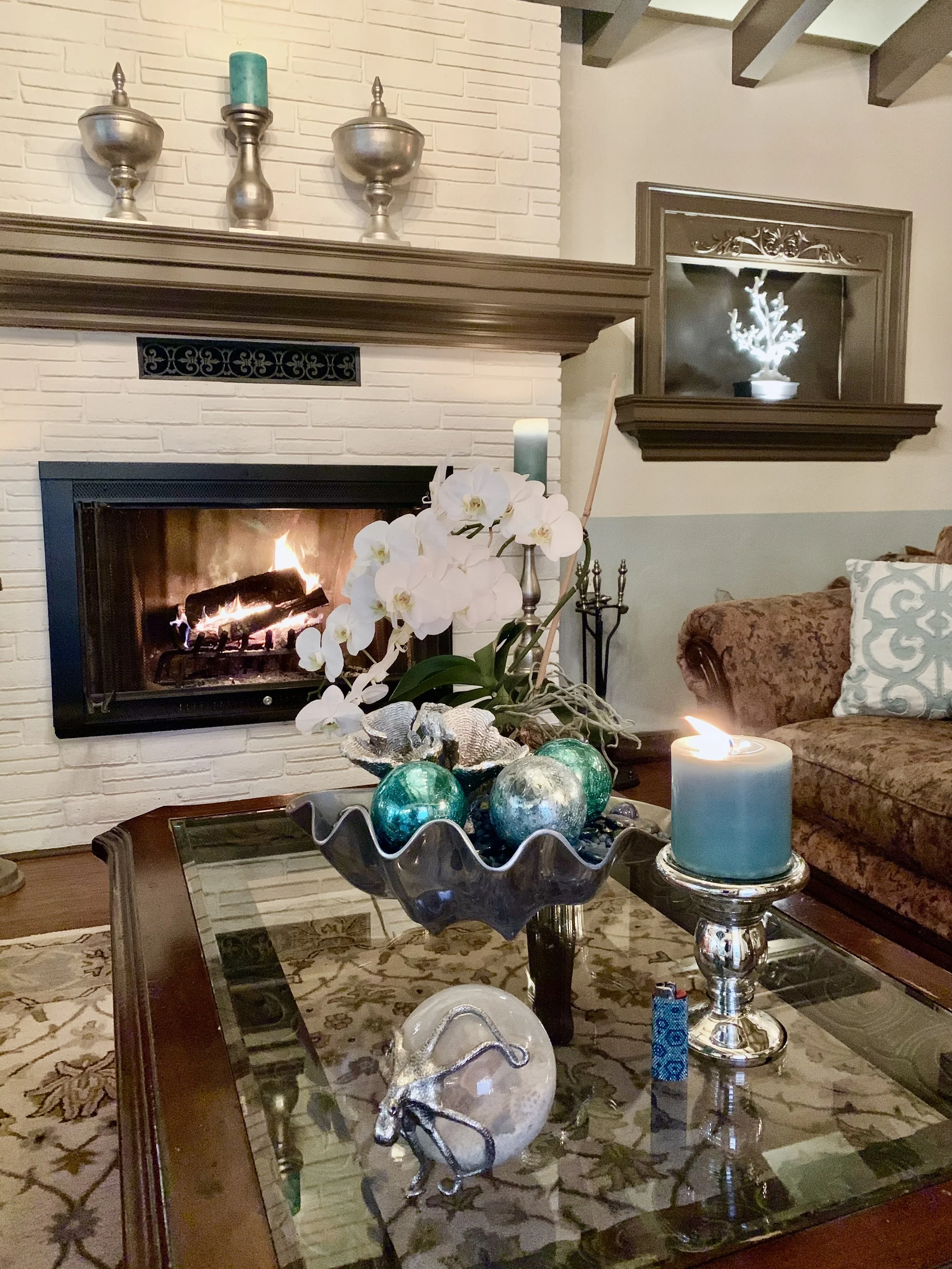 Transitional Mediterranean style living room with fireplace, coffered table, and rug in Fort Laudedale