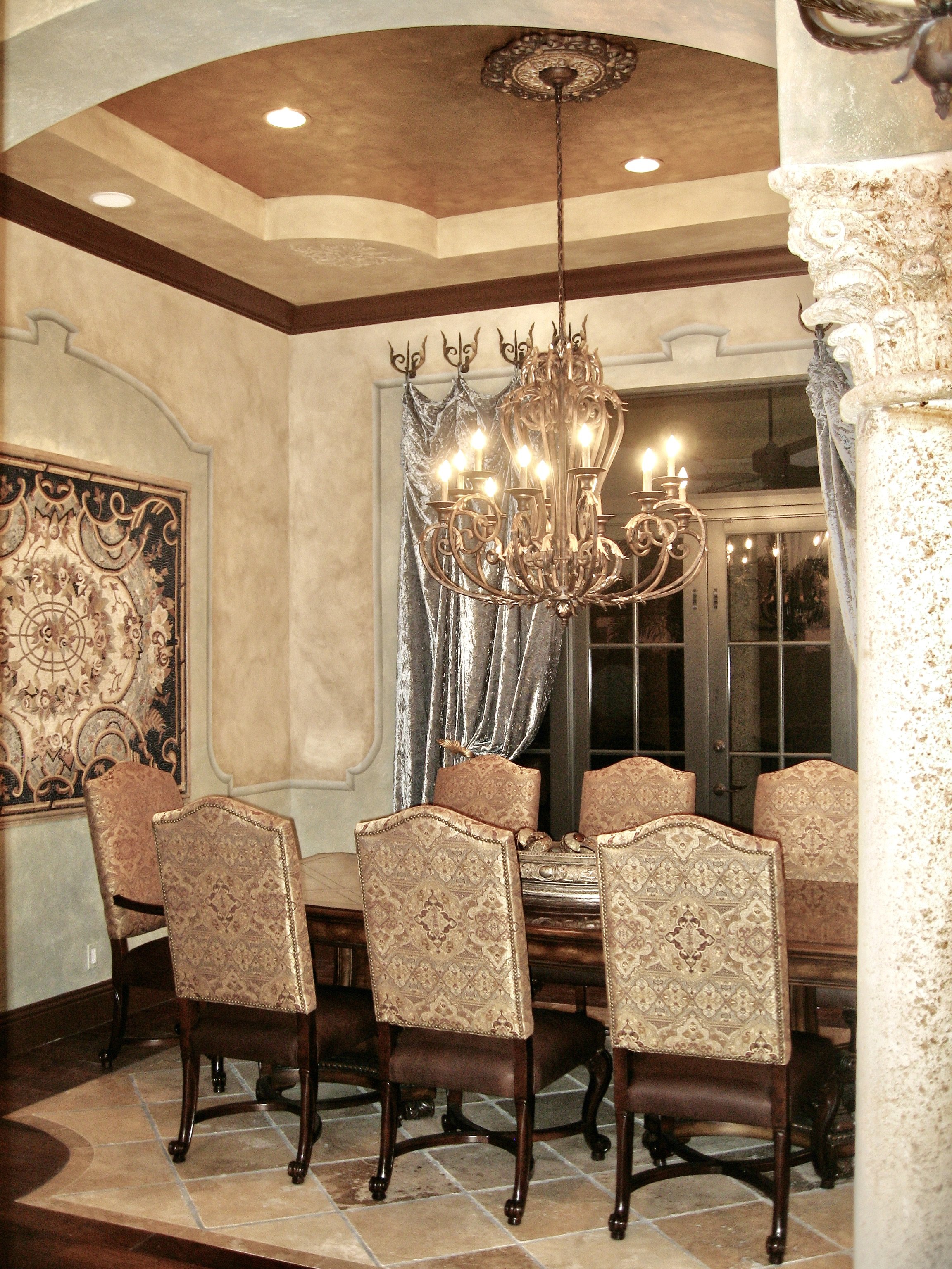Mediterranean dinning room with luxurious gold leaf tray ceiling in Weston