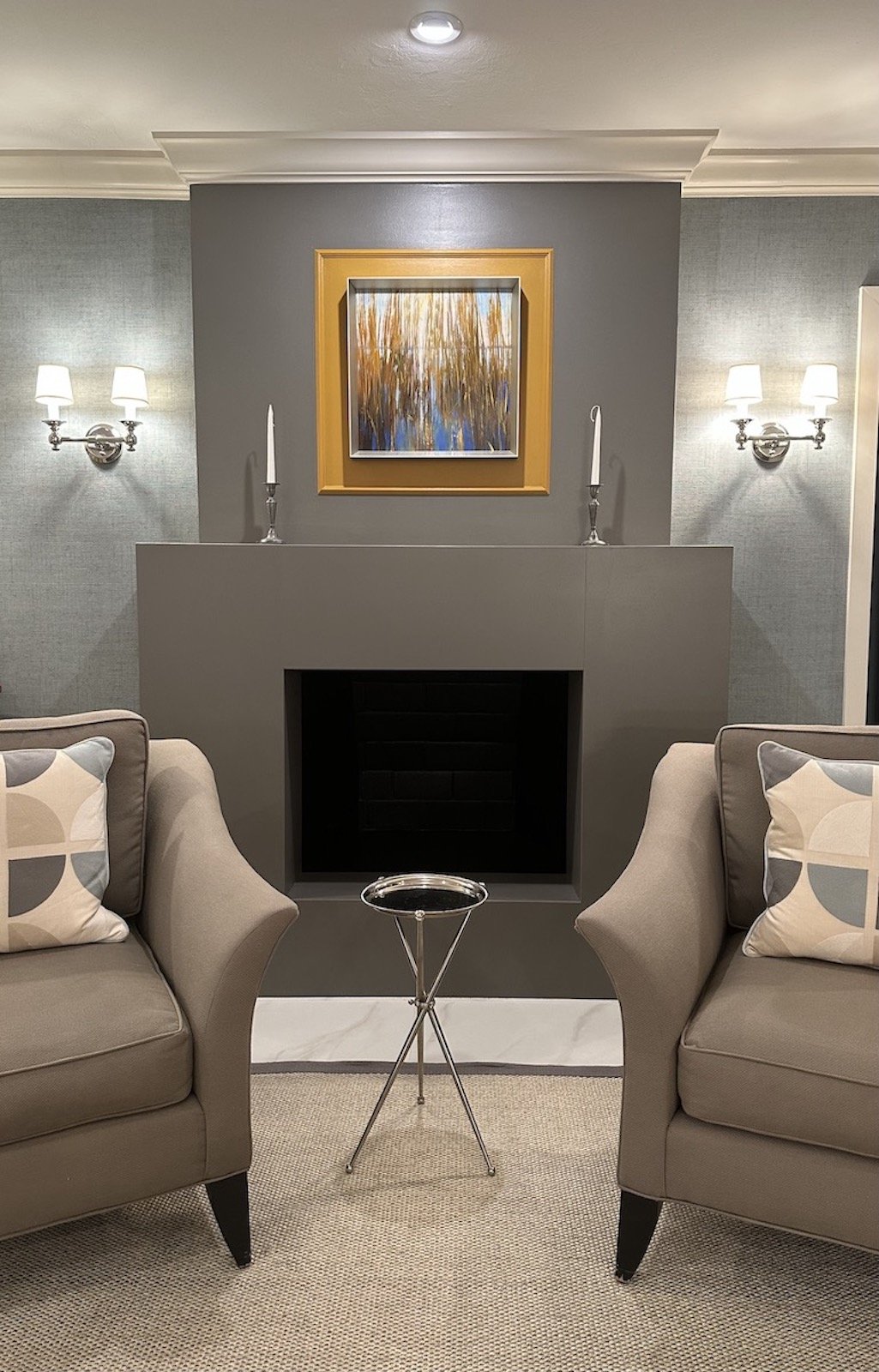 Modern Mid Century fireplace with modern flanking sconces and traditional crown molding