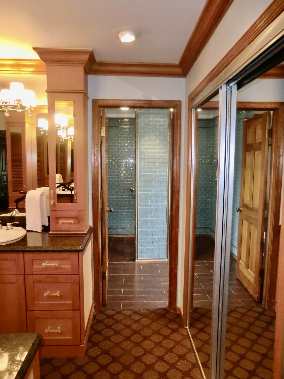 transitional dressing area looking through doorway into open walk in shower