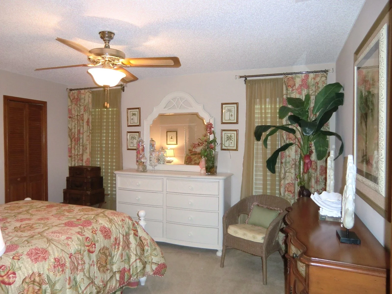 coastal style bedroom with tropical bedspread, white furniture in Palm Beach