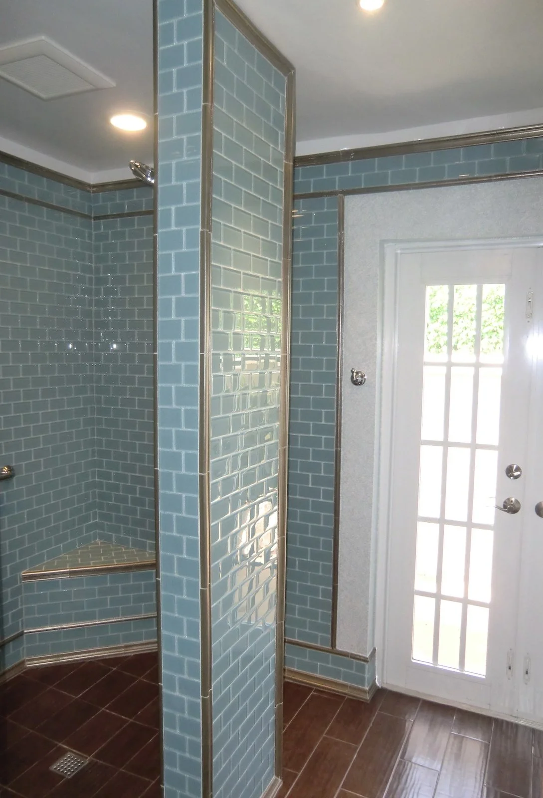 Coastal walk in shower with aqua glass tiles and silver trim in Delray Beach