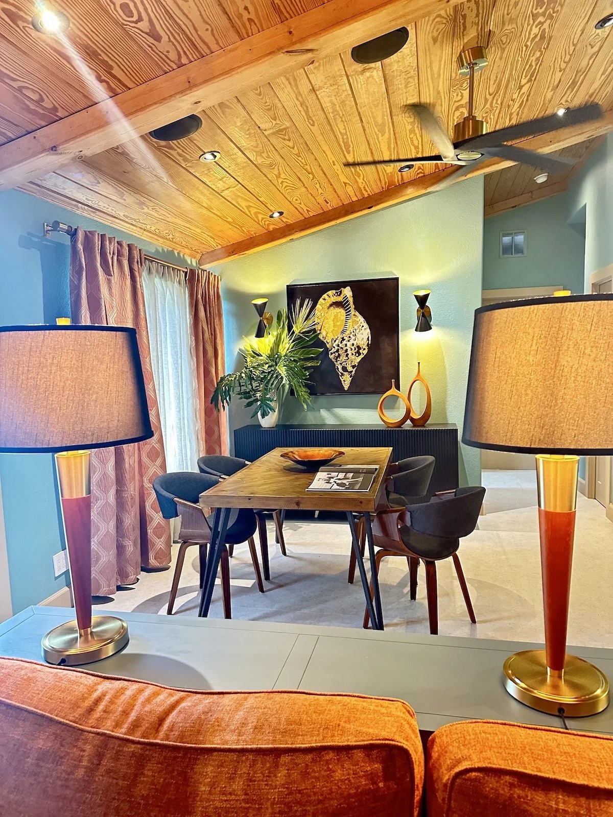 mid century modern dining area with wood ceiling