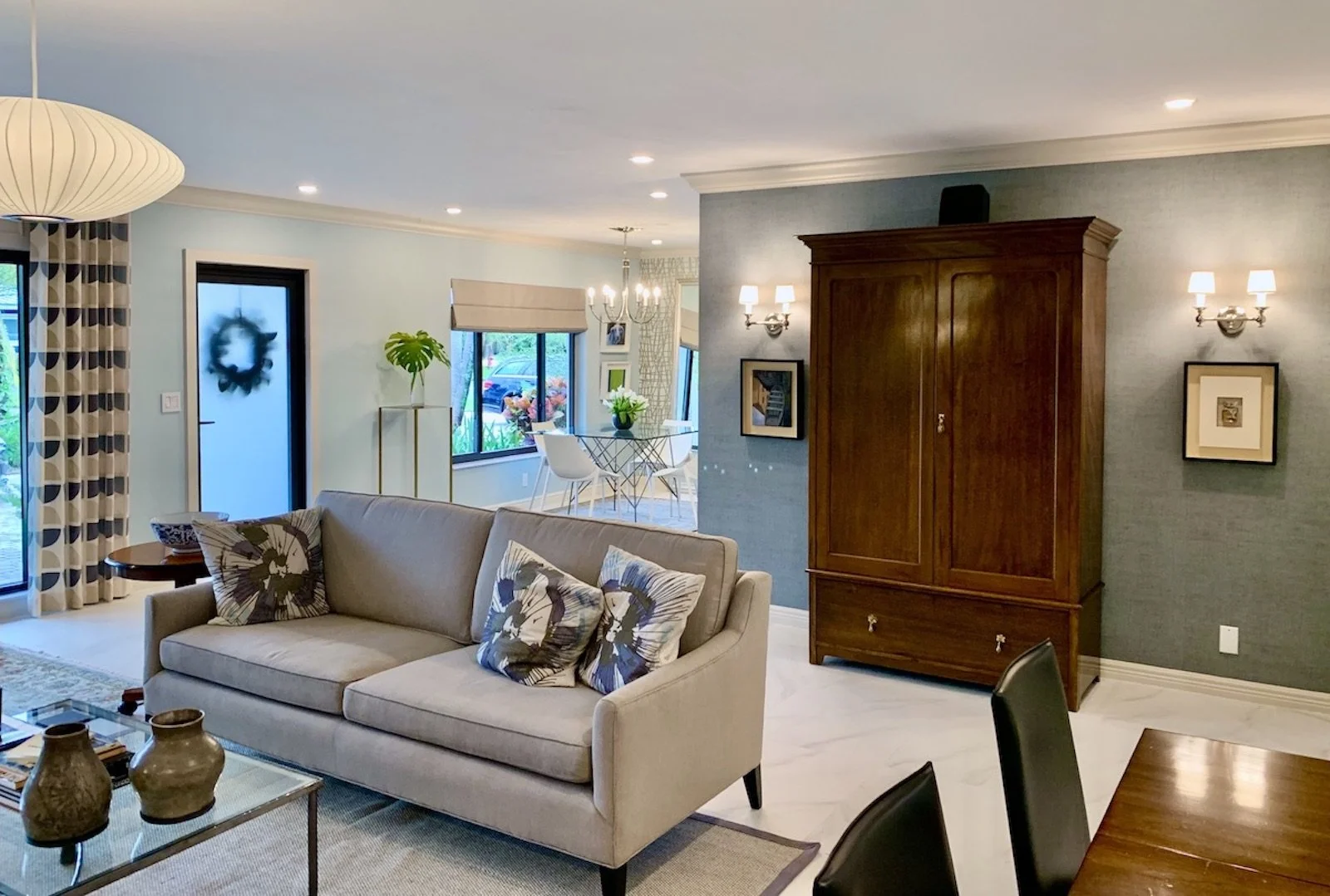 living room with modern sofa and traditional armoire with flanking modern sconces in Fort Lauderdale