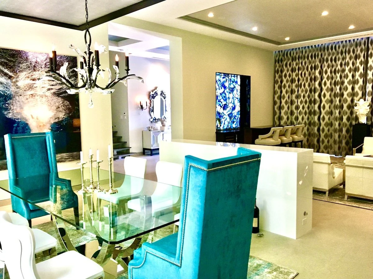 Modern dining and great room interior design in Fort Lauderdale with turquoise dining chairs, open-concept living, and contemporary lighting.