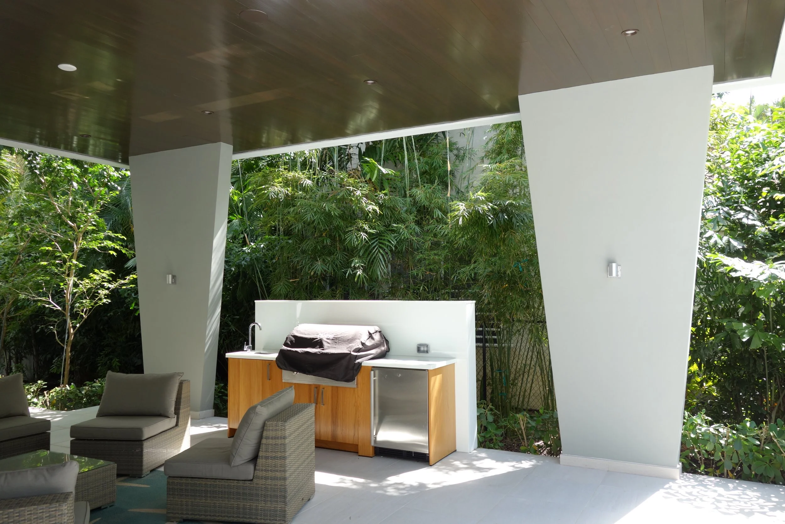 tropical patio garden with grill before home remodel in Fort Lauderdale