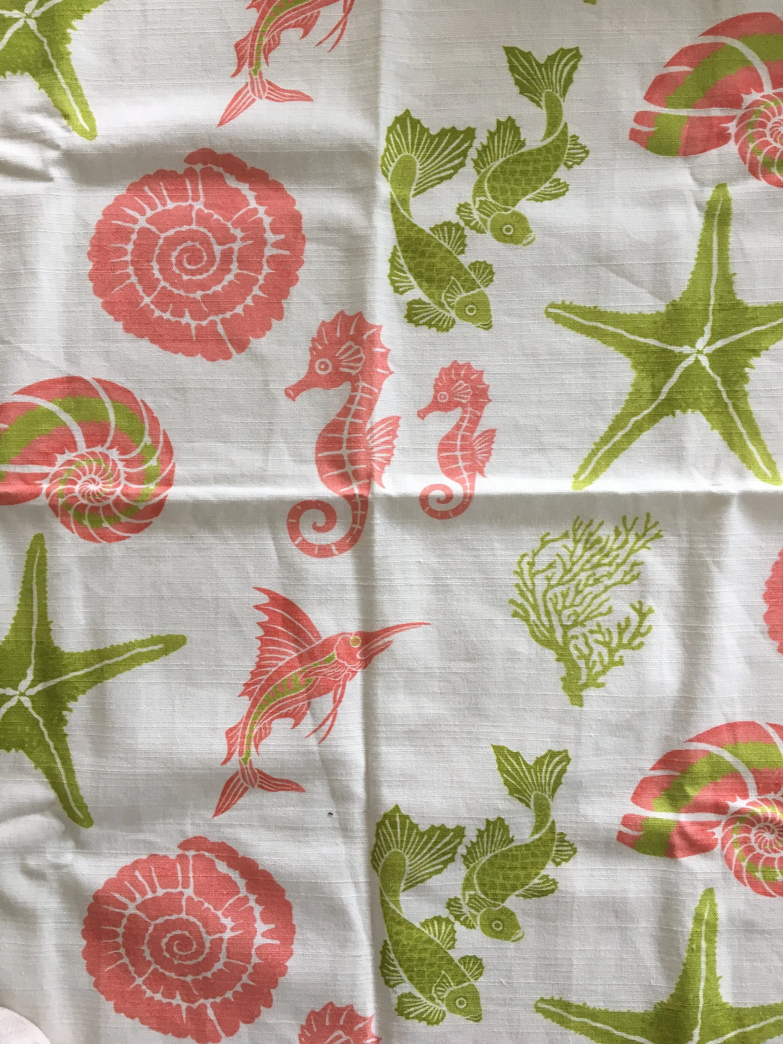 tropical fabric with coral and green fish and shells on white background