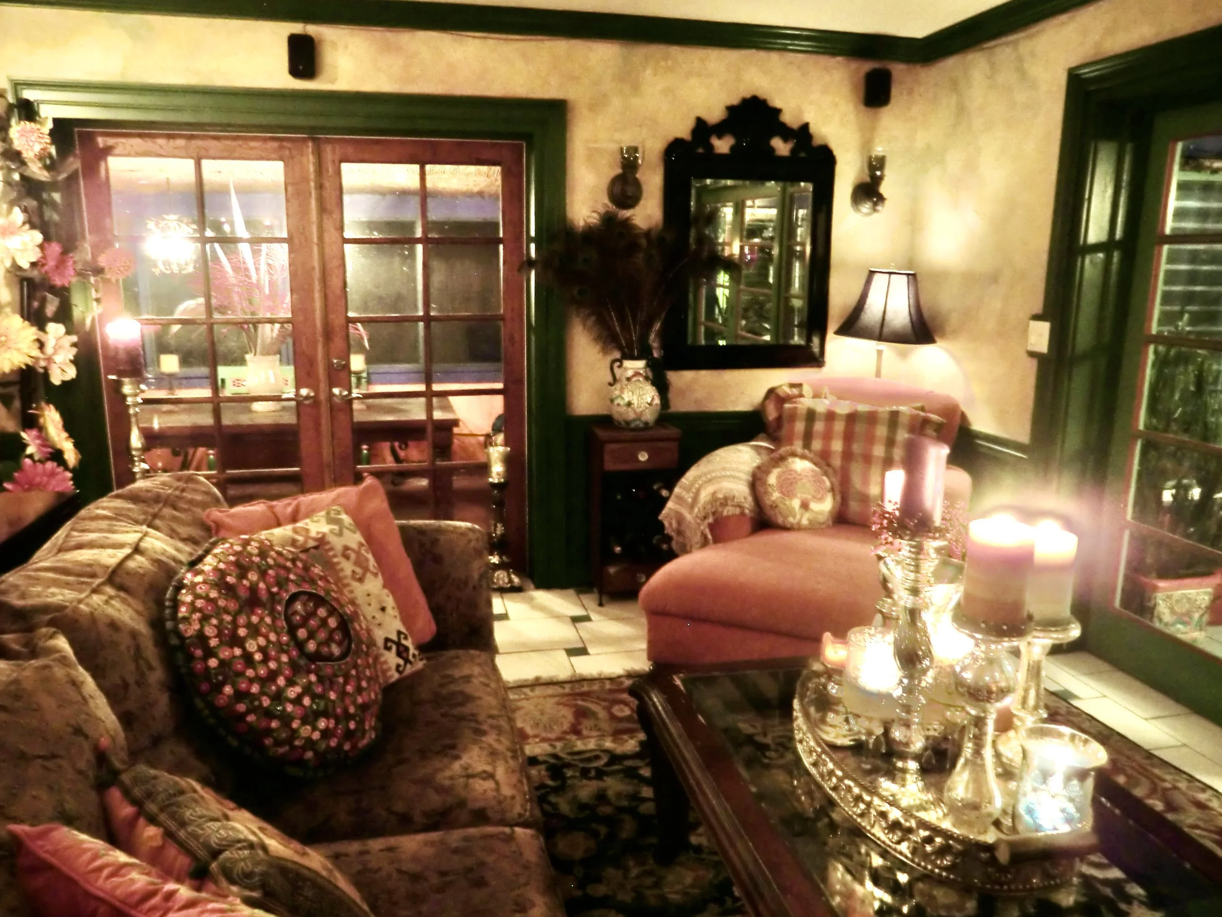 Spanish Mediterranean style colorful living room with coral chaise and Venetian mirror