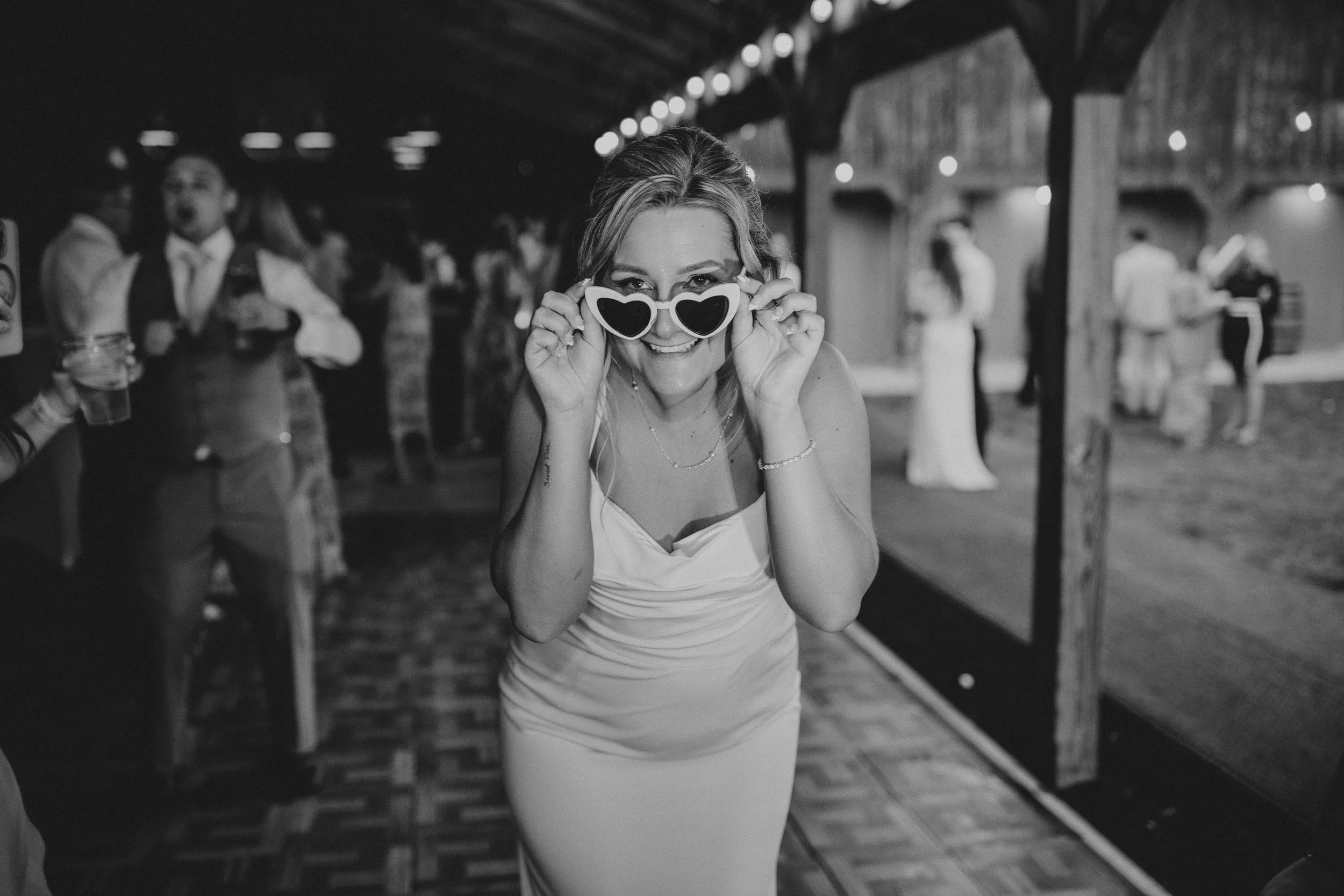 Bride looking right at you during wedding reception. Photo by Wendy Thibodeau Wedding Photography