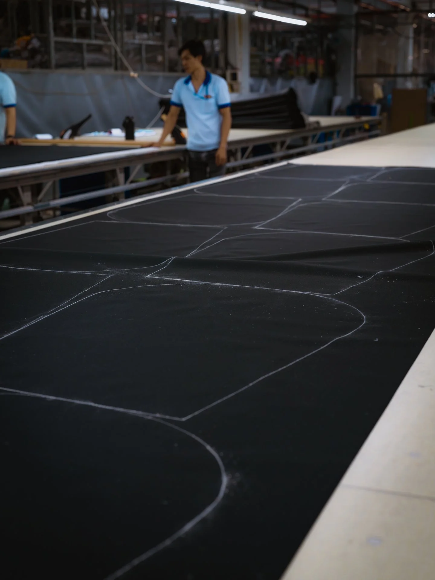Photo of pattern drawn on fabric at a factory of how the fabric is supposed to be cut