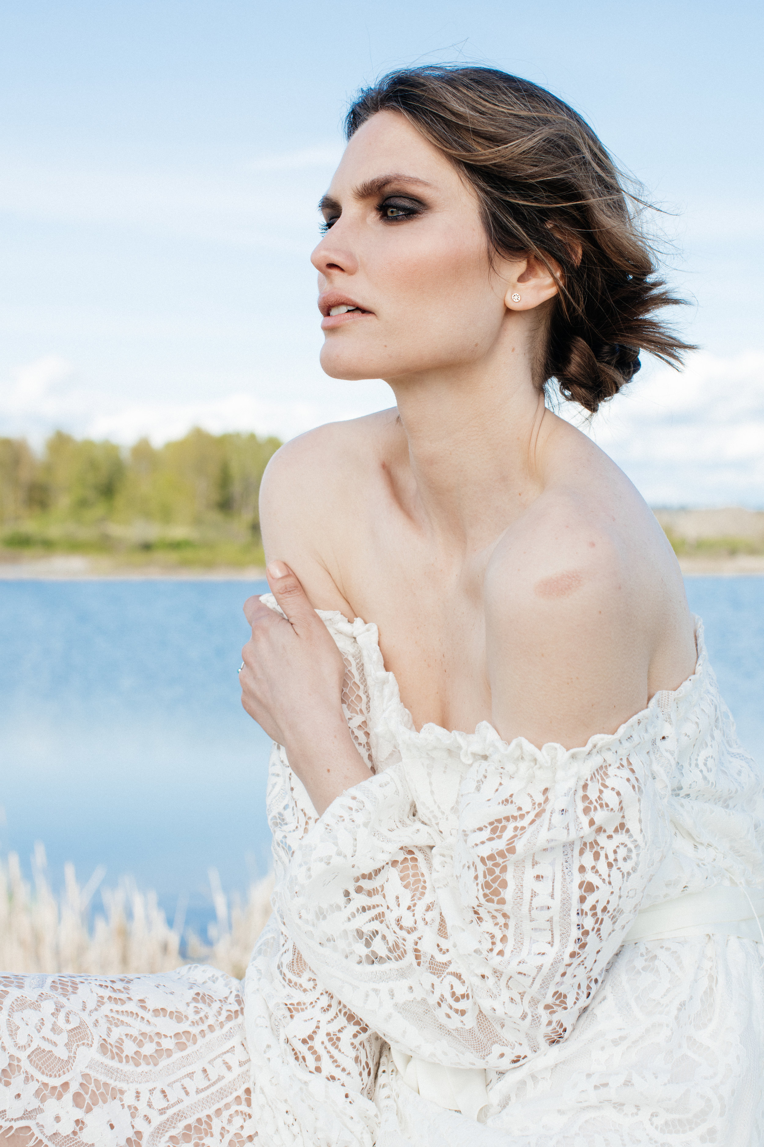 Model Kristy McQuade wearing a white lace dress on a editorial fashion photoshoot. 
