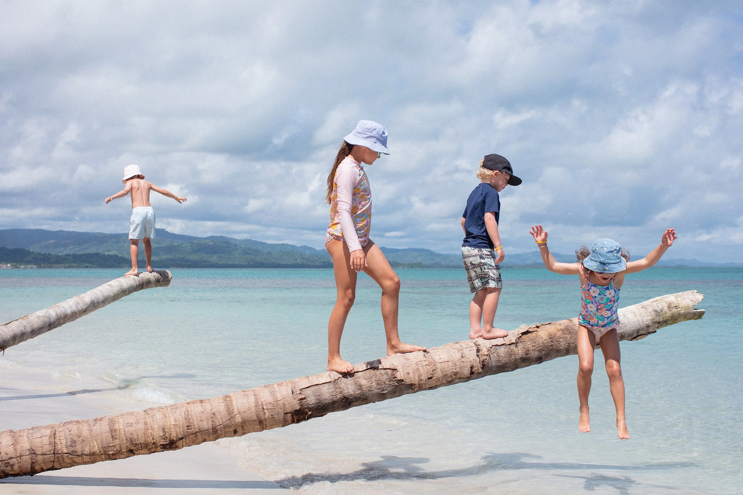 Travel lifestyle images of kids playing on the beach by the ocean in Dominican Republic at a Club Med resort in Miches created by commercial photographer Anick Violette.