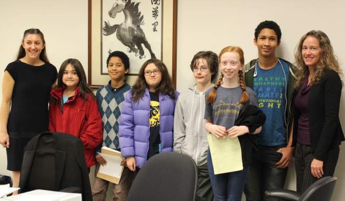 Andrea Rodgers (far left) and Julia Olson (far right) with six of the Washington youth plaintiffs.