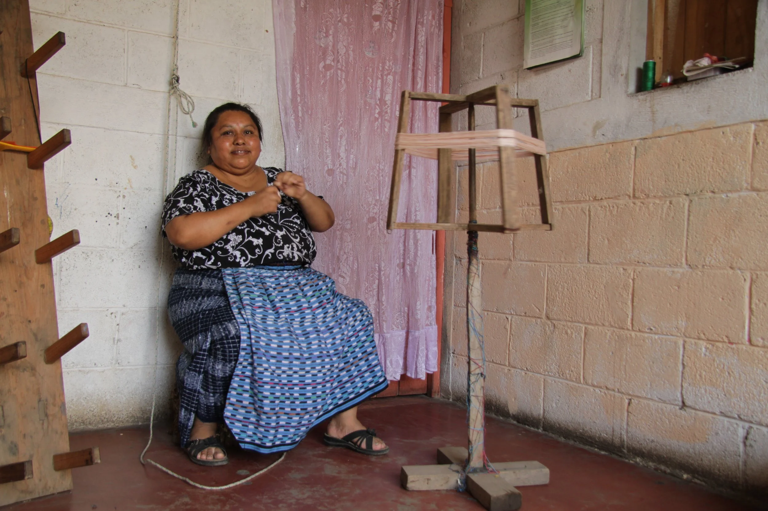 Next the women spin out the yarn.