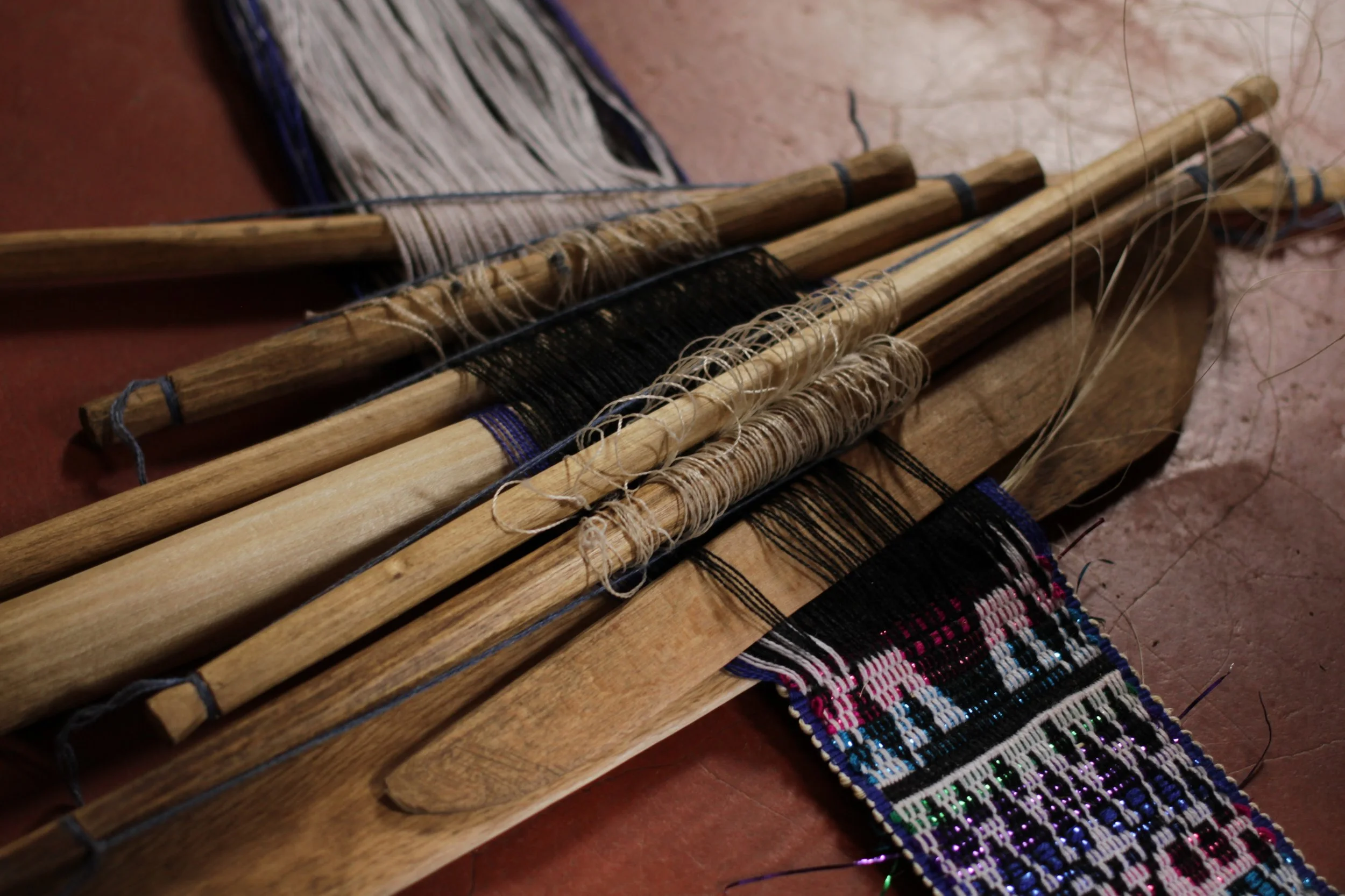 Finally they are ready to weave! The artisan will decide what patterns she wants to create, and will choose the appropriate number of rods to support it. &nbsp;The greater the number of rods, the more complex the design.