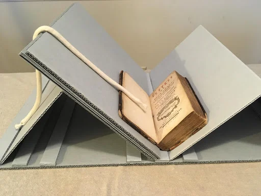 Image of a collapsable book cradle with additional spacer boards to provide more spine support.