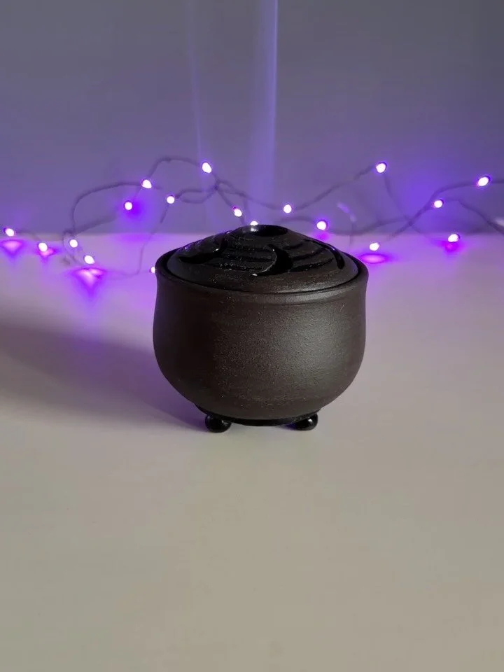 A witchy little Crescent Moons 🌙 Incense Cauldron. Wheel thrown of super dark brown porcelain. It was supposed to be black but my kiln got a little hot, so yay for happy accidents! The dark brown is really warm and charming. Glazed with gloss black 