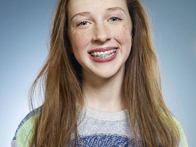 Smiling red-head girl with braces.