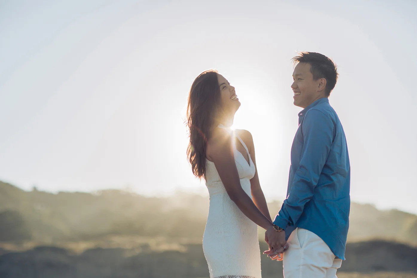 bakers-beach-couple-laughing-during-a-sunrise-engagement-session-macy-yap-photography.jpg