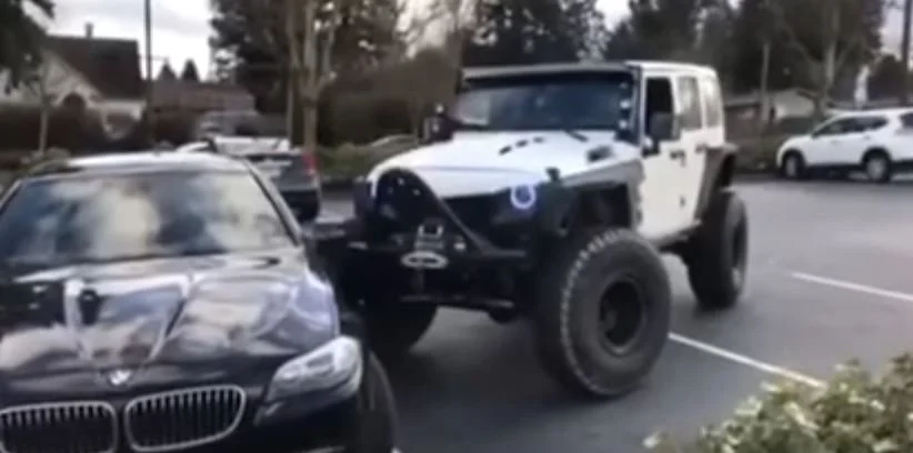 A BMW Took Up Two Parking Spots, So a Guy Pushed It with His Jeep