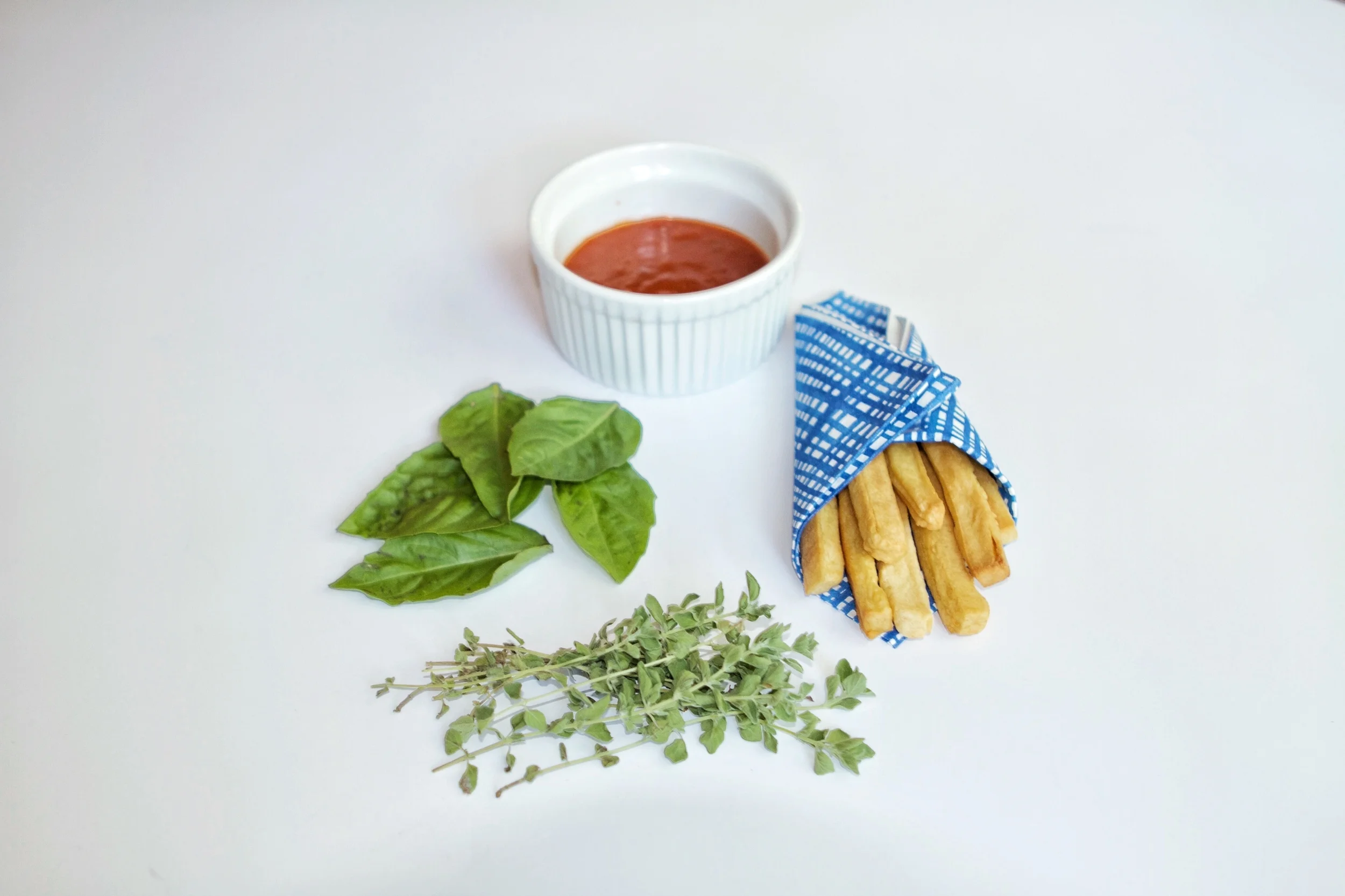 IMG_5046_Marinara Faded in Background with Herbs and Fries in Foreground.jpg