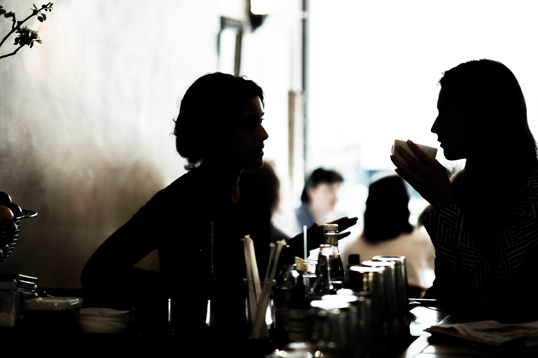 Silhouette of two people chatting at the bar 