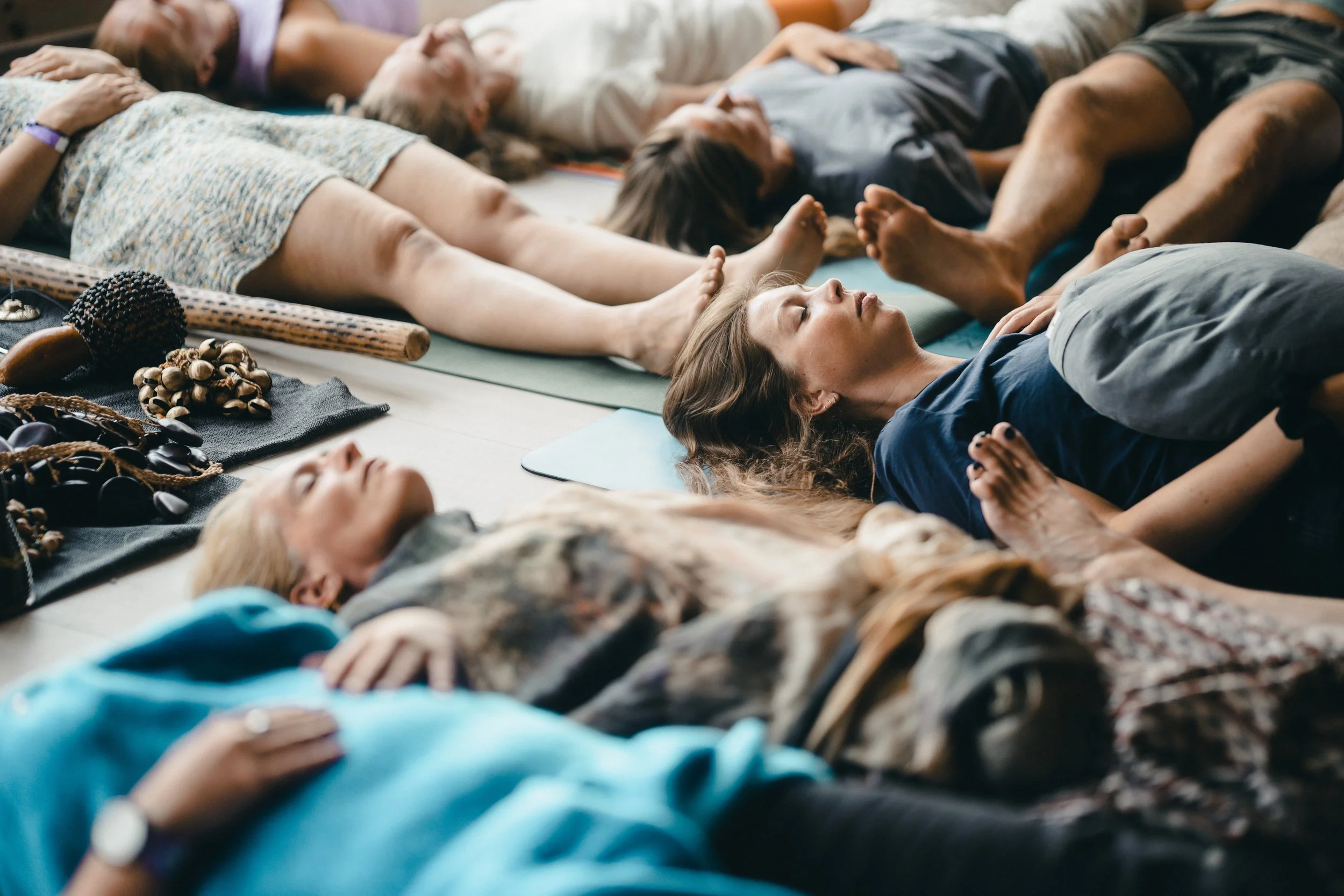 A group resting together in deep relaxation during a session at the festival