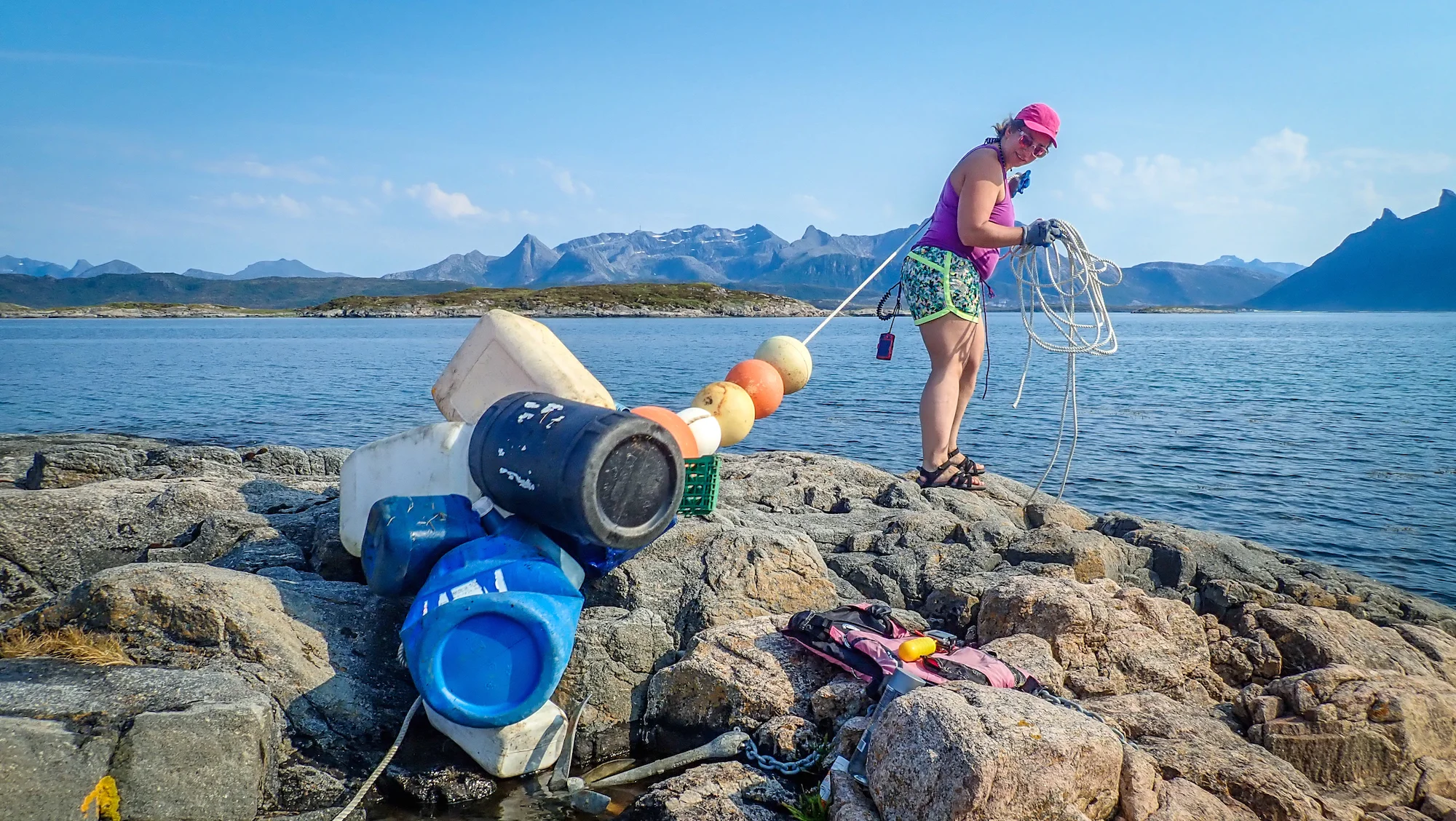 Wendy finding an inventive way to remove the many fishing floats and jerry cans that we found.