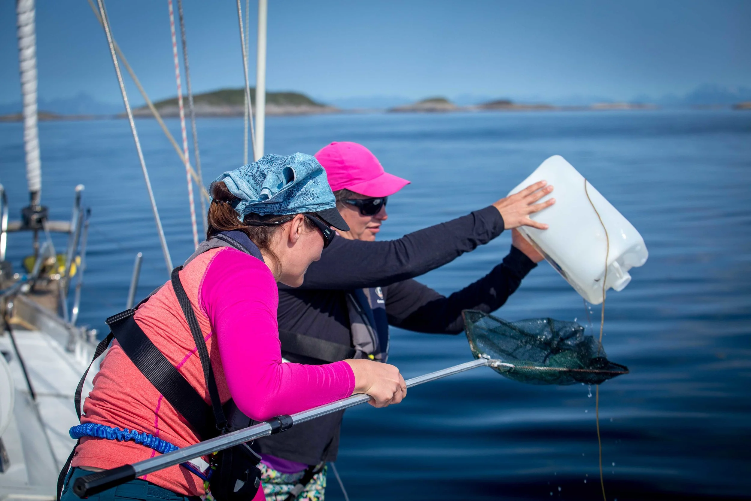 Lisa and Wendy fishing some plastic waste out of the ocean