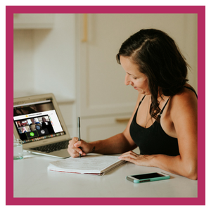 Woman at computer, taking notes.
