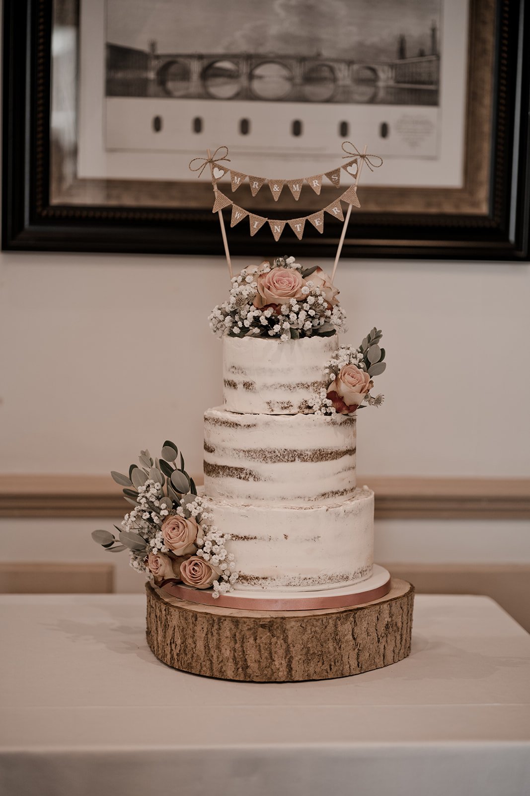 Flower bunting semi-naked wedding cake