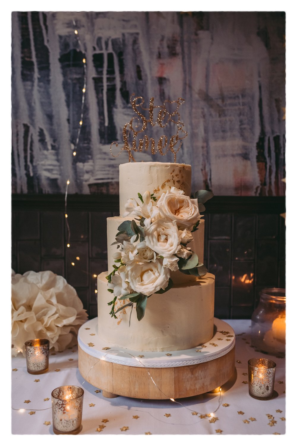 Buttercream wedding cake with gold leaf