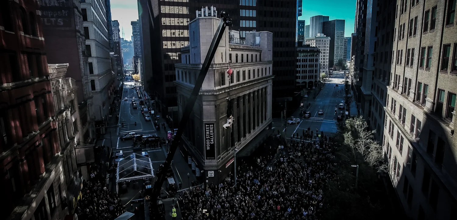 Lee Terbosic suspended from a crane above the crowd at Wood Street and Liberty Avenue during Houdini 100 on November 6, 2016