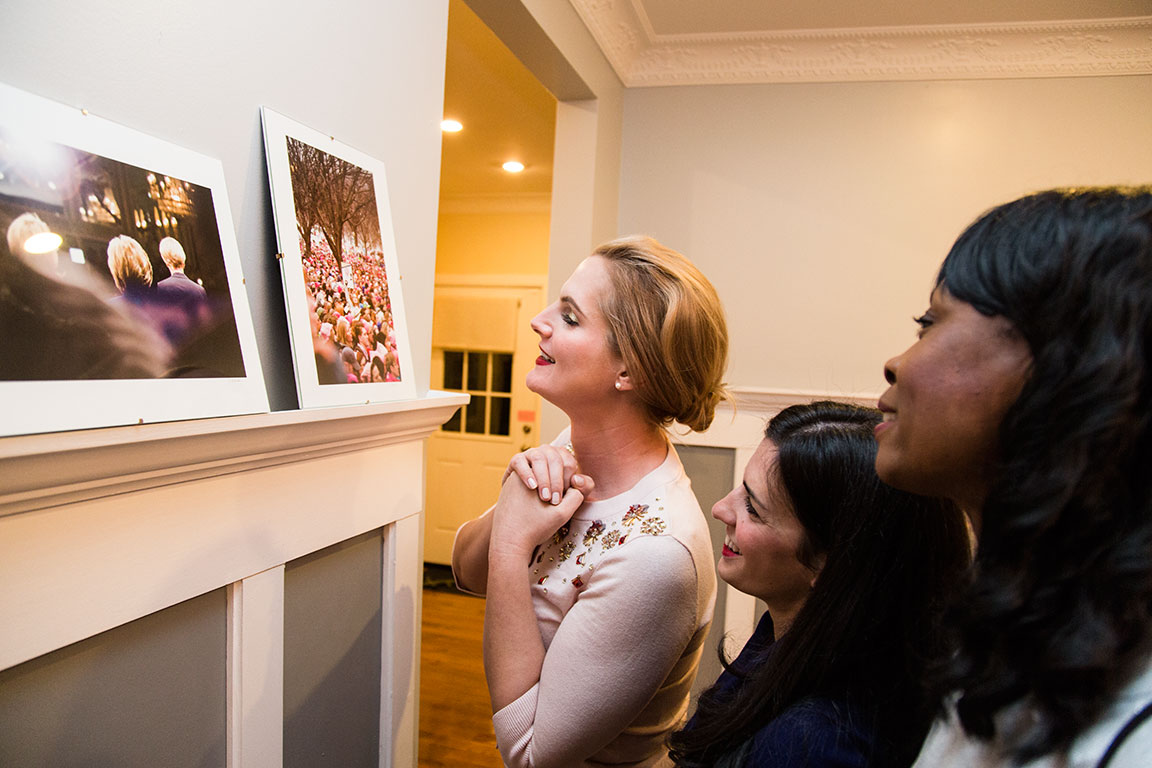 Members of the Hillary Clinton Brigade, Ella Frederick, Racheal Barasch, and Susan McMillan admire a photo of themselves participating in the Women's March on Washington, D.C.&nbsp;