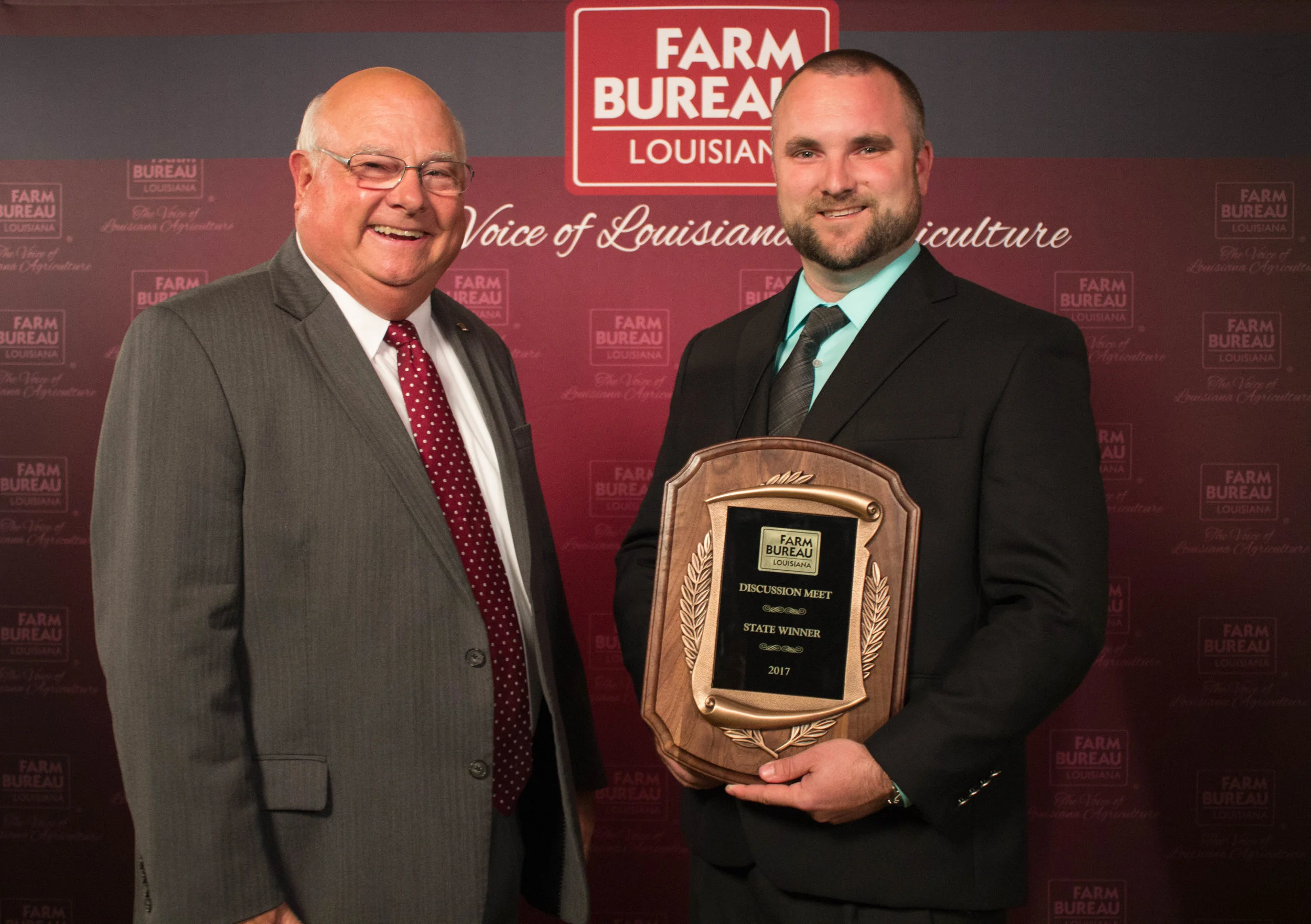 Adam Caughern (right) of Caddo Parish wins the 2017 Young Farmers and Ranchers Discussion Meet. The award was presented by Louisiana Farm Bureau President Ronnie Anderson.
