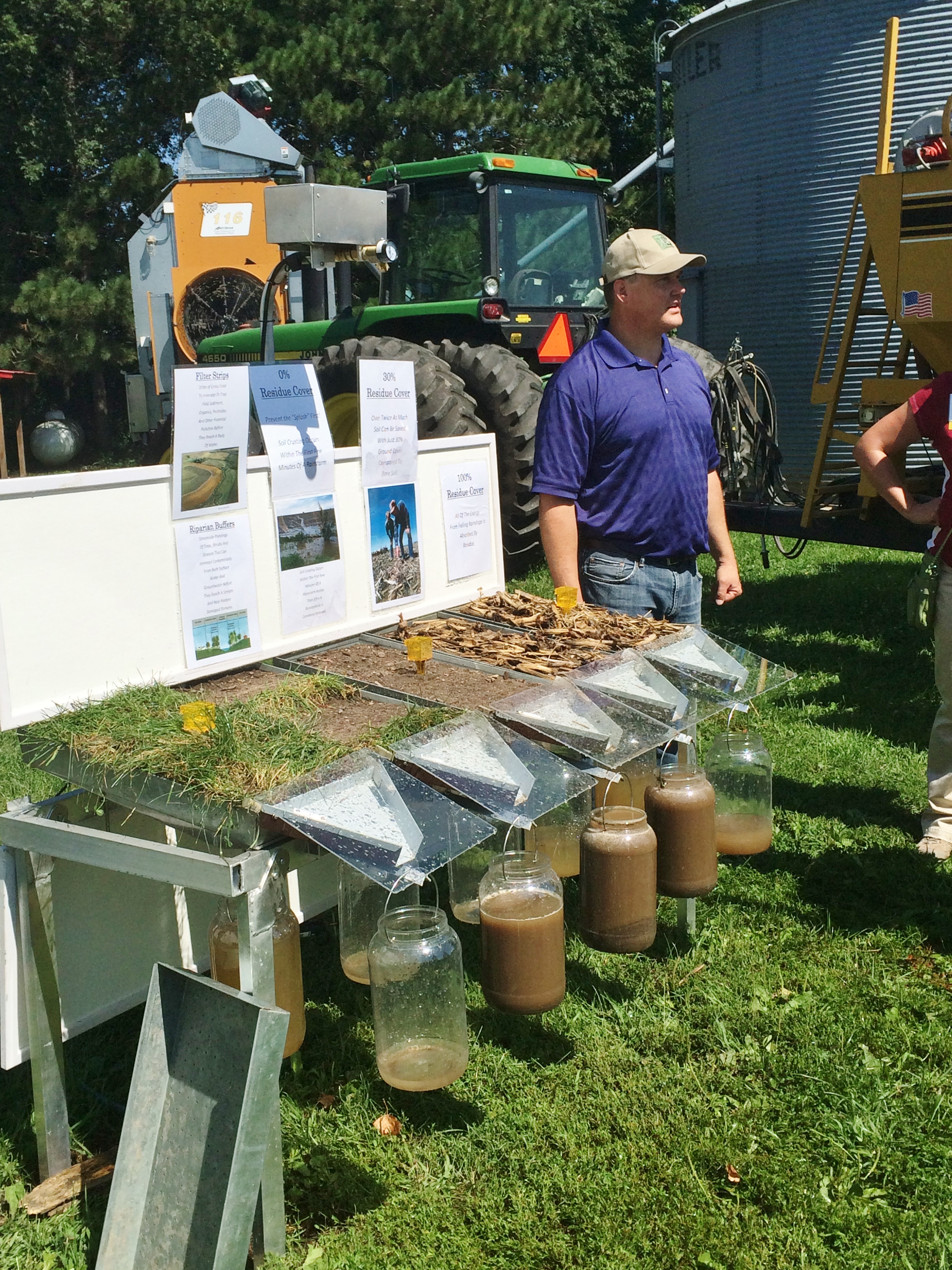 Demonstrating the effectiveness of buffers, as compared to bare soil or crop residue in keeping the soil on the land. Part of a tour at the Legvold farm in Northfield, MN sponsored by the Conservation Technology Information Center.