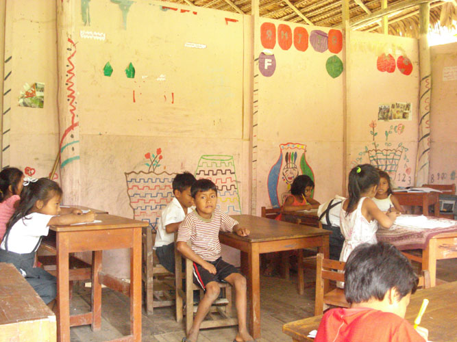 Typical rural class room with thatched roof and open walls.