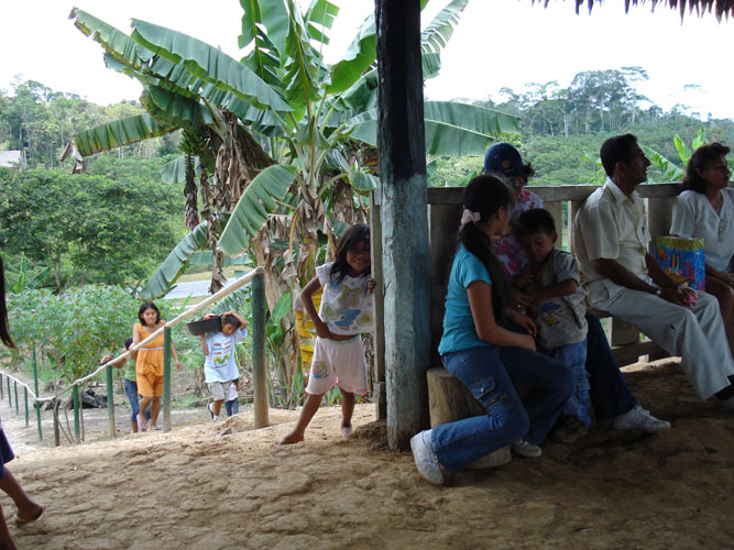 Community residences participating in Sunday morning meeting. Notice little girl smiling in back of post.